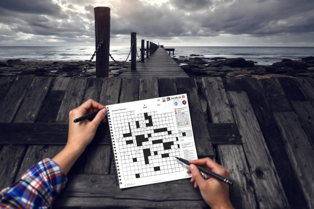 Deux mains remplissant un puzzle de mots croisés sur un ponton