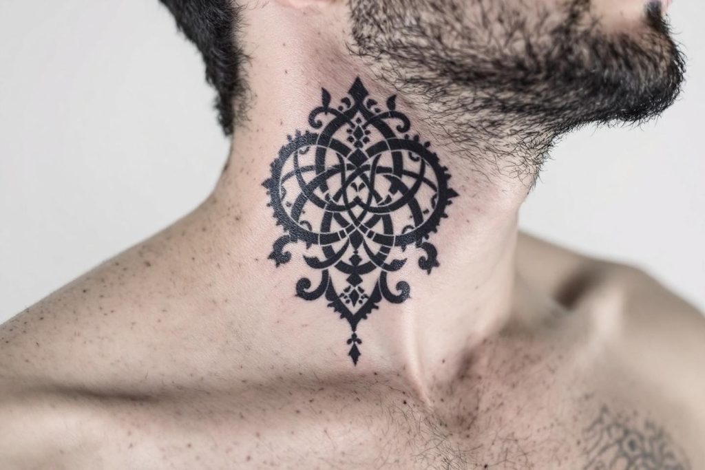 Motif ornemental noir complexe tatoué sur une nuque velue